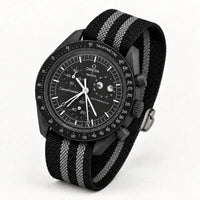 Black fabric strap with two grey stripes on MoonSwatch Moonphase New Moon