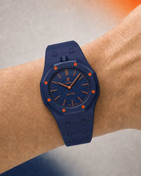 Deep blue link strap for the AP x Swatch Royal Pop Orenji Hachi worn on the wrist | WatchCollab