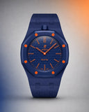Deep blue link strap and case on an AP x Swatch Royal Pop Orenji Hachi, front view