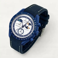 Navy blue premium rubber strap with white stitching on MoonSwatch Earthphase Moonshine Gold