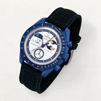 Black perforated premium rubber strap with blue stitching on MoonSwatch Earthphase Moonshine Gold