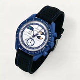 Black perforated premium rubber strap with blue stitching on MoonSwatch Earthphase Moonshine Gold