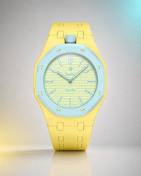Yellow link strap and case on an AP x Swatch Royal Pop Blaue Acht, front view