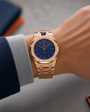 Royal Pop Orenji Hachi worn on the wrist with the WatchCollab gold steel integrated bracelet